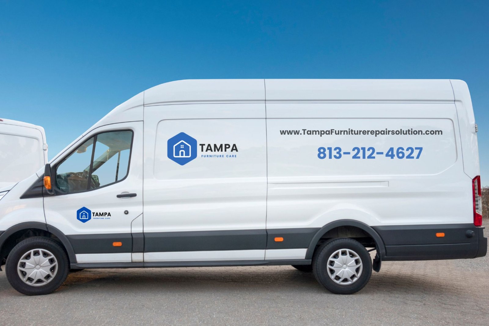 Side view of a white van with the Tampa Furniture Restoration logo, website, and phone number against a clear blue sky.