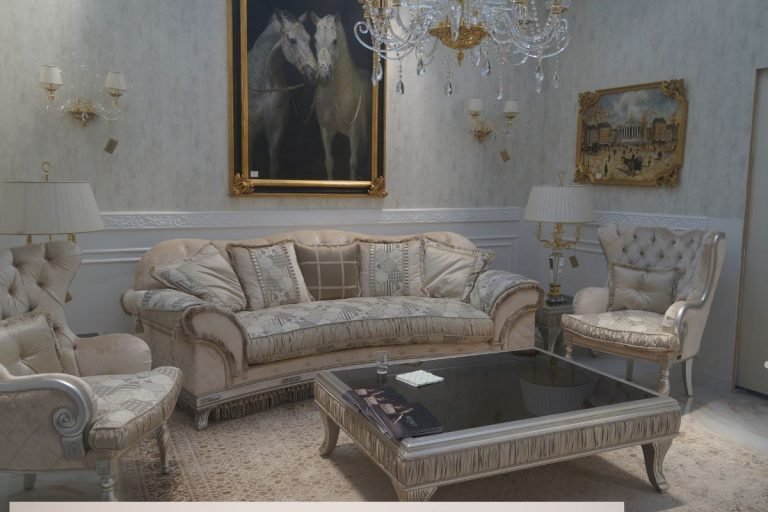A living room featuring a chandelier, a painting on the wall, and furniture undergoing repair.