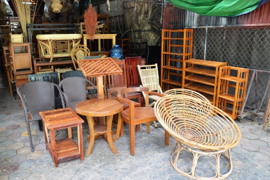 Outdoor furniture setup featuring a cluster of chairs and tables, ideal for dining or relaxation in an open space.