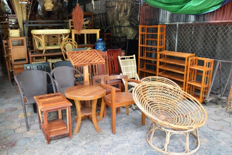Outdoor furniture setup featuring a cluster of chairs and tables, ideal for dining or relaxation in an open space.